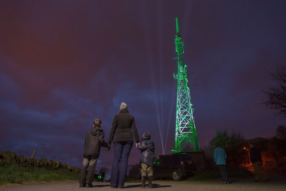 Crowds gather on top of Beacon Hill above Halifax to watch a lightshow staged by Dewsbury based eco firm Ploughcroft.